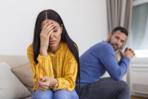 sad pensive young girl thinking relationships problems sitting sofa with offended boyfriend conflicts marriage
